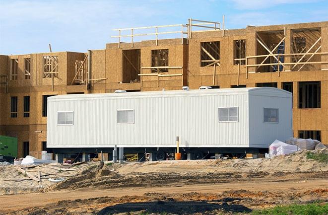 crane lifting modular building for construction office rentals in Mcclellan